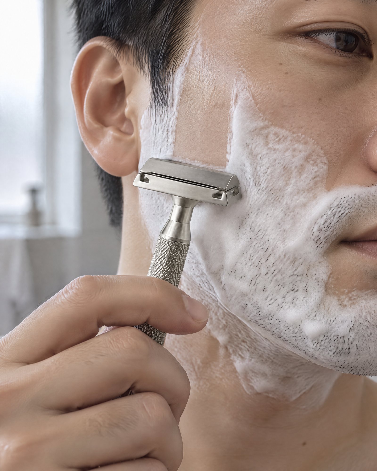 Shaving with the Safety Razor, Silver, laid almost flat on a lathered cheek