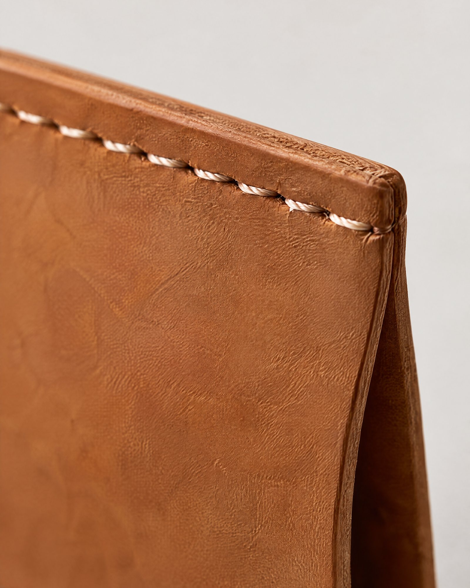Close-up of the stitched edge of the Travel Sleeve, Tan